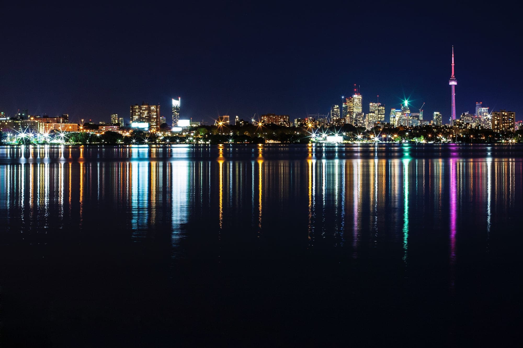 The Toronto skyline at night reflected in the lake